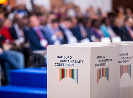 Podium at the conference, with the audience blurred in the background